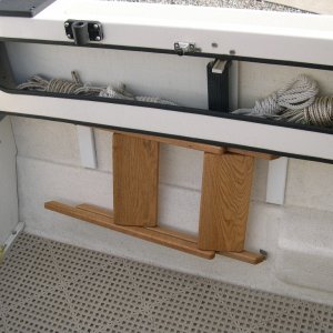 (CAVU) Steps folded flat and stowed on hooks under the starboard shelf.