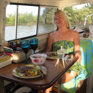 Media '(020 20) 1st Mate Toby getting ready to enjoy supper in cool comfort.  Roughing it?' in album '(014 14) Window brackets disconnected and standing vertical to hold window open.  Blocks in place for AC to sit on.'
