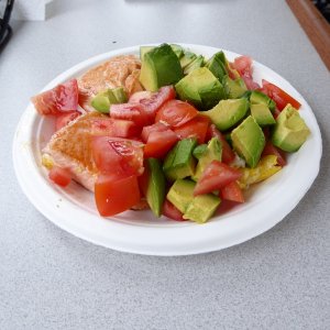 Salmon, eggs, tomatoes, and avocado for breakfast.  A strange mix.