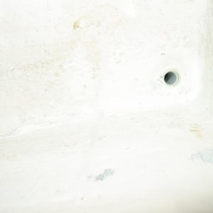 Media 'Close up view of drain hole through the hull.' in album 'Plugged side drain holes.  Built bottom to drain to starboard corner.  Also fiberglassed between anchor locker and port/stbd lockers.'