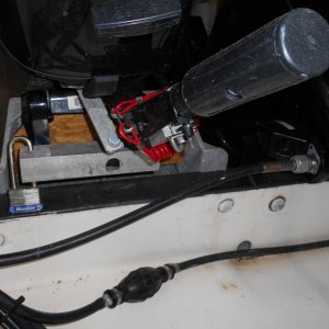 Made kicker lock from aluminum square tubing, split down one side, and drilled for a padlock.  The plastic coated steel types don't last long in salt water. 
Also note the bracket to rig trolling motor steering link to main motor.