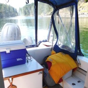 8. The side window unzips and folds back to attach with velcro to the top of the window aft.