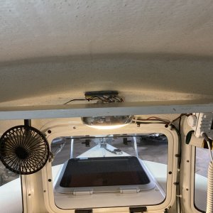 Media '03 moved the junction plate off of the shelf and added a small clam-shell where the wires for the dome light go through so as not to snag them with stuff' in album '01 before - helm shelf with VHF, stereo and bus bar in the middle right behind the stereo'