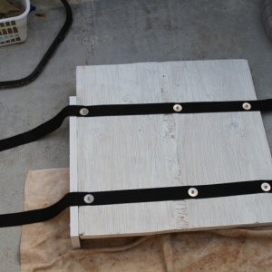 Straps secured to bottom of base.