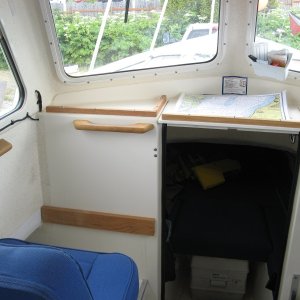 Added the 3/4 by 3/4 wood strips on the dash area.  Also some teak grabs for the 1st mate.   July 2010
