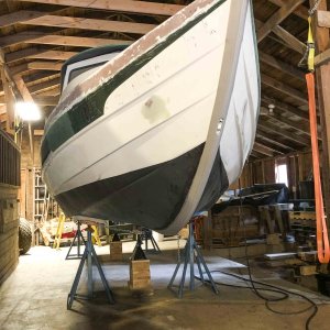 Bottom work is finished and the boat is now supported in six locations. Note the yellow ratchet strap and orange recovery strap hanging to the right.