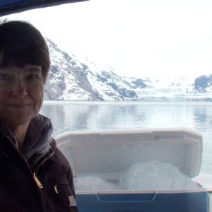 Jo-Lee in front of John Hopkins Glacier with ice chest stuffed with burgy bits.