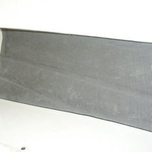 1/4 inch closed cell foam (similar to wet suit material) glued to fiberglass using 3M Super 77 adhesive spray
