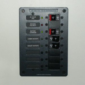 Close-up of AC panel. Red LED lights up when shorepower has incorrect polarity. Labels are backlit with LED's at night.