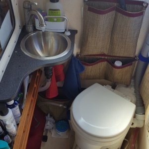 A tight fit trying to add the Airhead, sink, and storage for extended cruising into a CD 25 head, under the sink you can see the raw water foot pump that saves tank water.