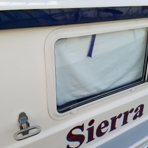 Dana\'s new step up top, a SS folding mast step.
Also one of Dana's co-workers did a marine grade professional coating on the dark blue brow and overhang, I polished it out a couple of months ago with my normal marine products and it didn't get shine and color like this!