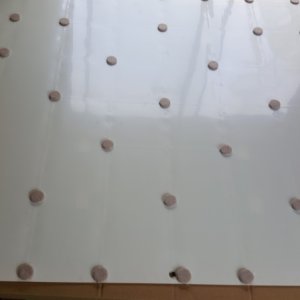 Felt spacer dots for the solar panel air gap, placed with a dab of silicone along side on the panel backing between the silicon wafers.