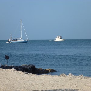 Photo taken from Black Fin's beach area. Seems to  be an anchorage. I'm not sure if they can dink in here for showers etc at the Black Fin marina or not. They have steps go into water,the rea is all lit up at night with LED lights looks pretty festive. Tables chairs and barbecue out here, short walk from our slip