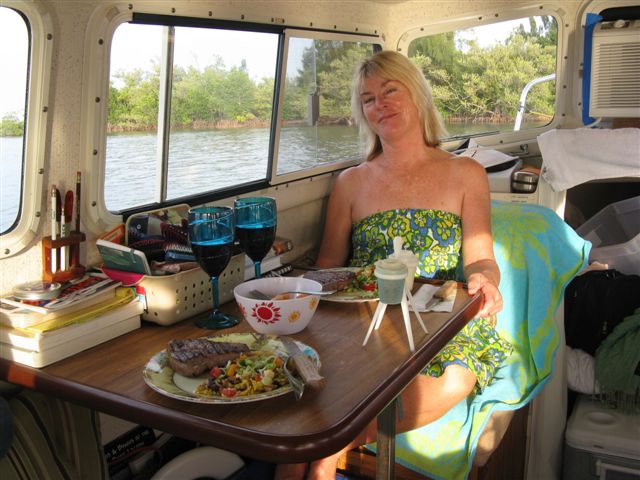 (020 20) 1st Mate Toby getting ready to enjoy supper in cool comfort.  Roughing it?