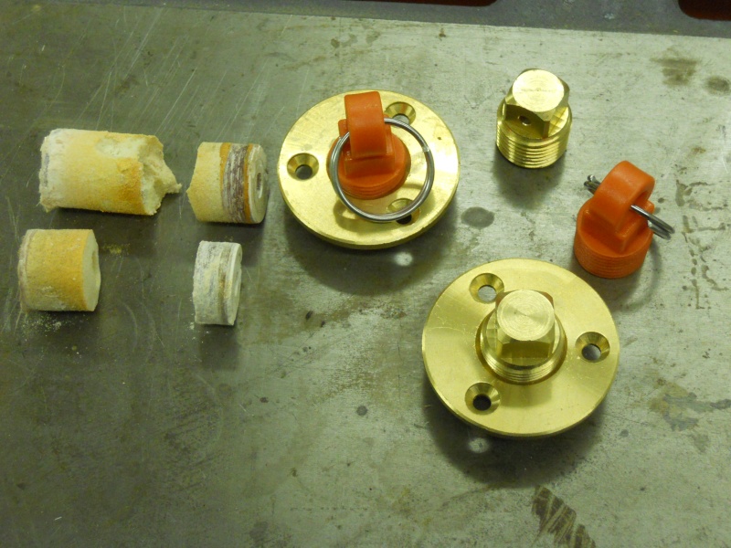 1" cores cut from transom. Closed cell foam core. Garboard flanges and plugs. Orange plugs are emergency spares.