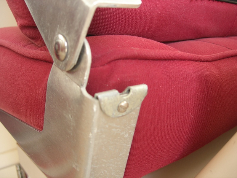 1" washer folded in half and set on to seat frame.   #4 screw used to secure it.   Seatback will now be in a more upright position offering better support.