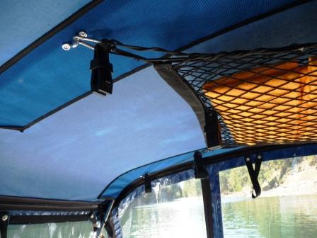 11. These black plastic locking clips work well for hanging towels or rain gear etc.
When we unzip and fold the top under and back for easier standing access into the cockpit, we hold the top in place with these locking clips.
