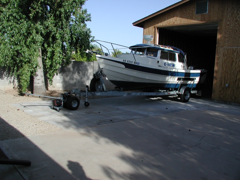12 volt trailer mover in action.  After entering RV garage, need to make sharp turn to right so motorhome can also fit.