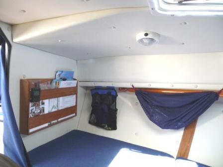 14. Extra storage in Cutty.
You can just make our the top end of one of our wooden boat paddels, held up in place under the deck by a velcro strap.