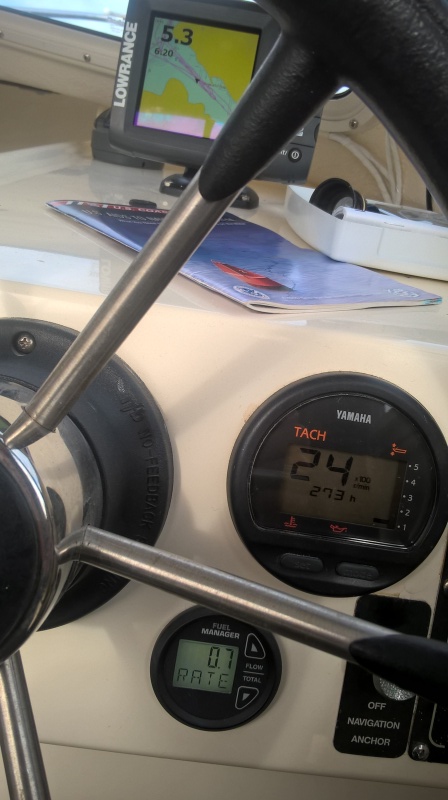 2400 rpm gives a SOG of 6.2 knots at .7 gallons per hour (supposedly 10 mpg, although I usually only get 8).  At WOT I have seen it go as high as 3.6 gph. 
 Yes, I'm only in 5.3 feet of water, but I'm heading out of the little bay right in front of my cabin.  It's cool.