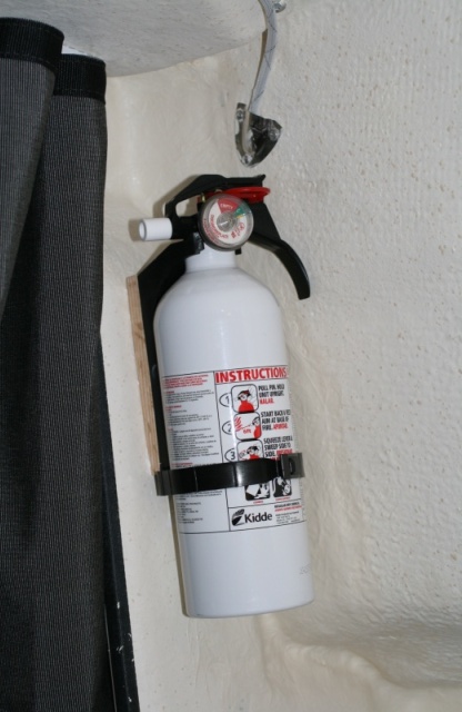 2nd fire extinguisher added to port bulk head inside the berth - screwed to piece of oak glued with 5200.