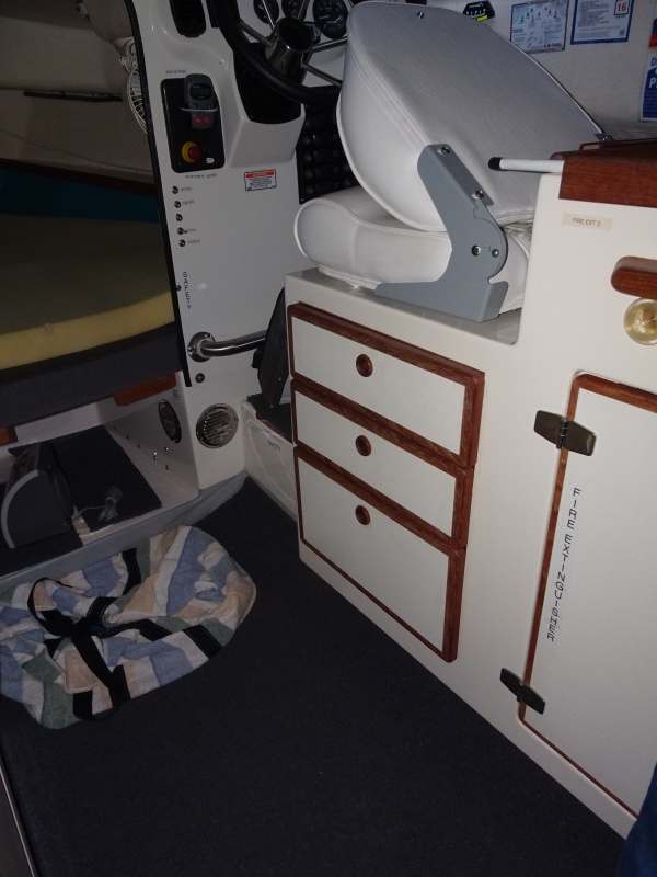 3 drawers under the helm seat. custom helm seat.  Ventilation for Inverter charger on aft and inner parts of Starboard V berth.  On the floor is bag which the AC unit sits in when not in the window.  This goes under the V Berth.  There is also vinyl loo mat on the floor of AC storage, and the cabin floor.  Dry deck under the mat.