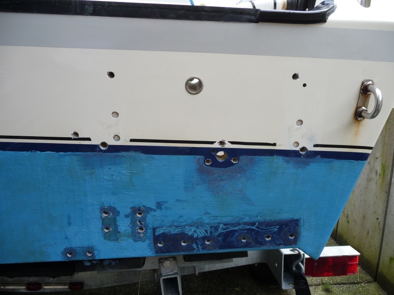 3. Number 10 screws drilled out with 3/8" drill bit, then additional yellow closed cell foam around the inside of the 3/8" hole removed with a "Dremel". 3/8" Swim step bolt holes redrilled out to 7/16".