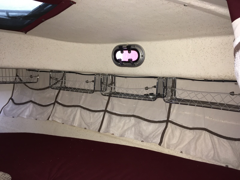 3 stainless racks mounted on each side, under deck.  Used to store clothing, towels, etc, during long term cruises.  Still have the mesh bags below them for additional storage.