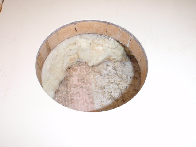 4 1/2\" hole cut for deck plate between fuel tanks.  On the left side you can still see moisture in the core foam.  This is after several days.