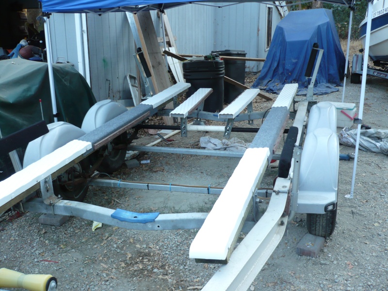 4x6x12' PT main bunks mounted just inside the outer edges of the 22' I have heard it is important that PT lumber NOT come in contact with aluminum. The bunks are covered with plastic slides though I left about 4' carpet only to get some friction.
There are two short plastic covered composite bunks that help support the transom weight. 2 keel rollers forward.