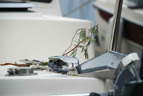 A branch of greenery on the bow to ensure safe returns