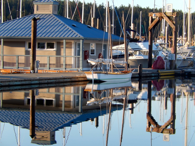A small sailboat among the reflections in Friday Harbor Marina