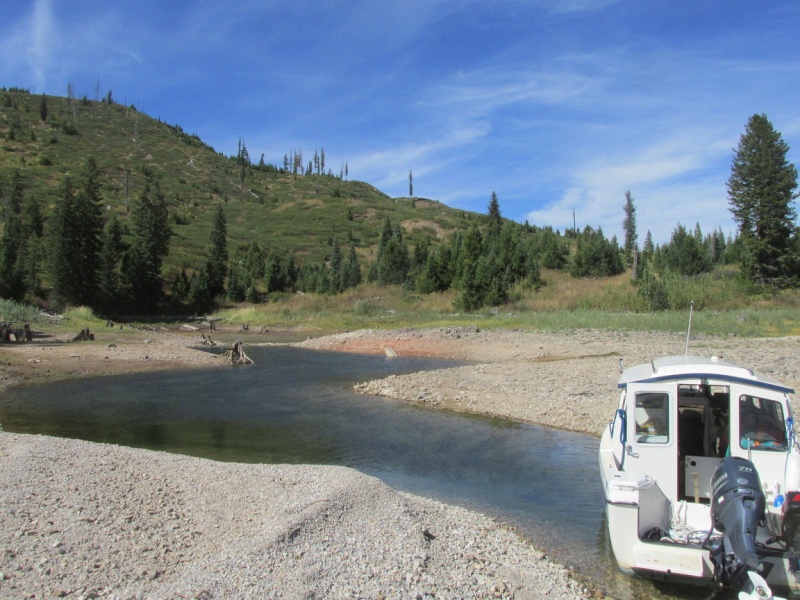 A stern breeze causes Mike to get the "Little Joe" sideways in a small creek on the west side of Jackson Lake