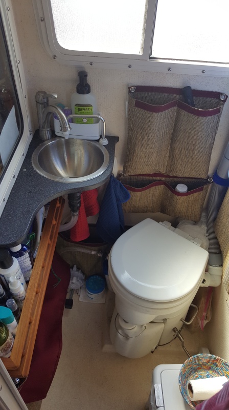 A tight fit trying to add the Airhead, sink, and storage for extended cruising into a CD 25 head, under the sink you can see the raw water foot pump that saves tank water.