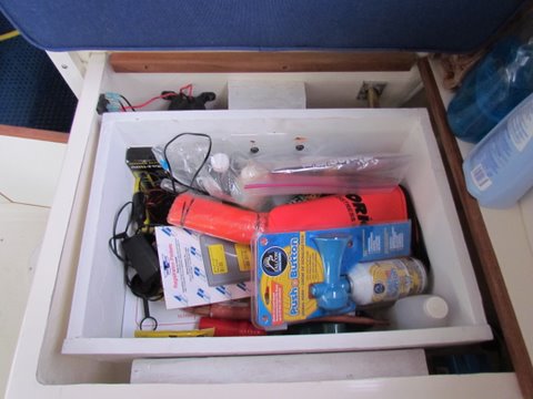 Added a box over top of my water tank which is located under the rear portside dinette seat cushion. Made out of 3/4"marine plywood used wood blocks mounted on either side then ran stainless steel lags into the blocks from both sides it's about 9" deep and does not come into contact with the water tank. Easy access for emergency flares etc about 14" x 14" x9" deep