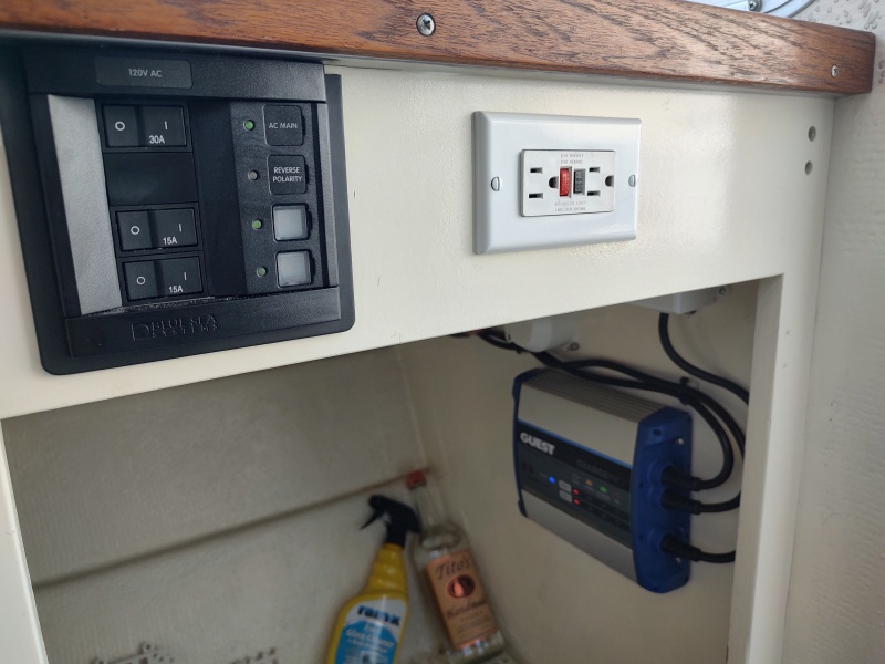 Added Blue Seas AC panel, outlet and battery charger.