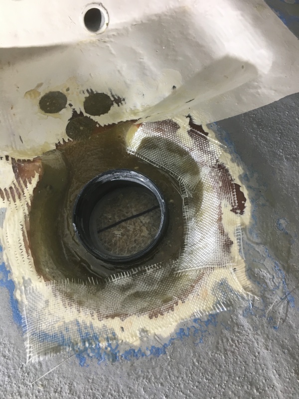 Adding layers of fiberglass for strength.