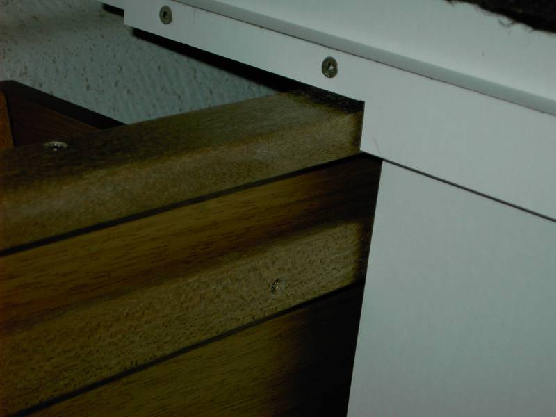 Aft end of forward seat. Slot in mahogany is slide for poly T shaped piece that is fastened onto sliding seat box. Mahogany is bin.