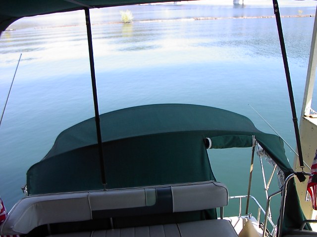 Aft view from helm. Cockpit has entire closure. Flying bridge has bimini and side curtains.