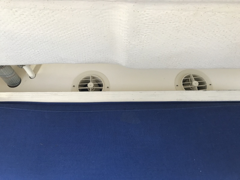 Air conditioner vents behind port bench seat.