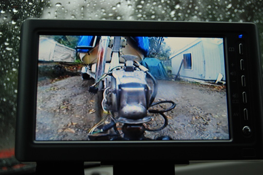 Backup Cam: Aftermarket "Peak" 7inch bought on E-bay $85 delivered. 15 min. easy install. Picture in rain at dusk with wet camera lens. Makes it super easy to attach boat single handed.