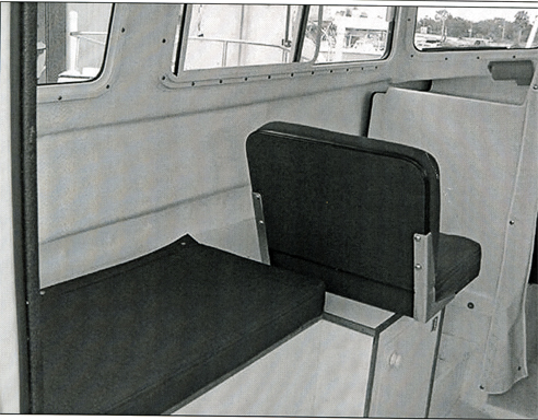 BEFOFE: Original port bench seat with copilot chair for CD 22 Commuter version. Starboard side was identical. This side now has been modified to form a bed and houses a 20 gallon water tank.