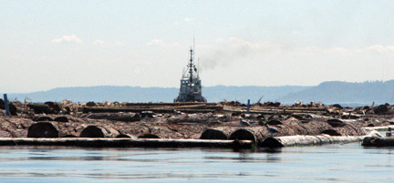 Behind a tug w/logboom