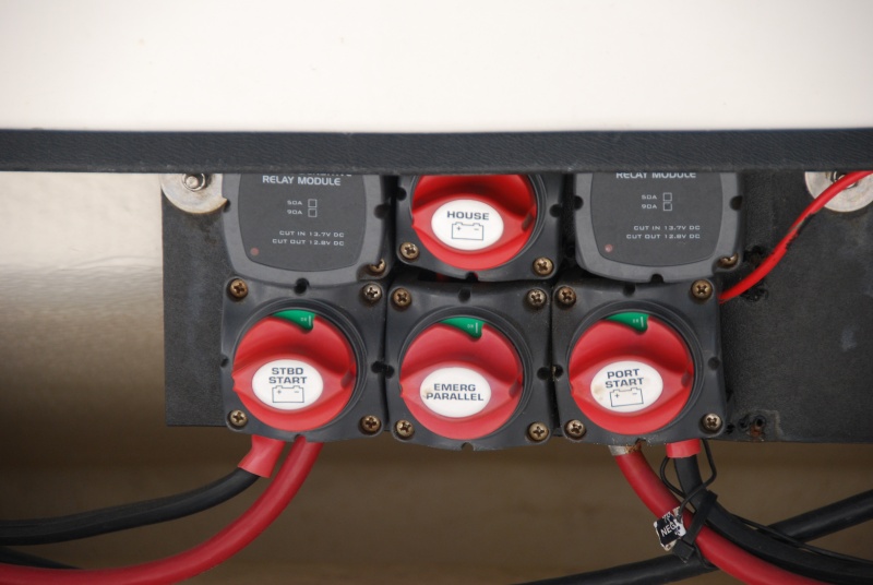 BEP 717A-100A 3 battery mounting at stern. 
Relays can be seen, top row, at the left and right of the House battery switch. 
Emergency Parallel switch for the 2 start batteries is in the bottom row, middle, directly below the House selector switch. 
These switches are all in the "ON" position. 
This allows GUEST 2610A Charger to charge the 3 on-board batteries. 
The how: the charger is wired to the Starboard and House batteries directly, allowing the Port to be charged via the Parallel Switch. 
When  either Start battery reaches 13.7V the VSR will cut in, the charger can thus support them all.