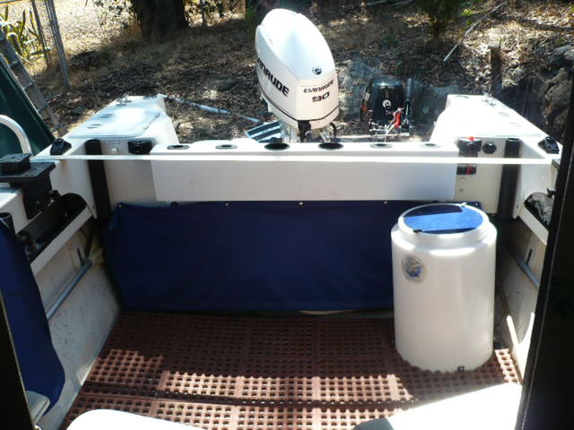Blue canvas snap on with galvanized weight bar at bottom gives clean look but easy access. Now store a west marine 4 step ladder behind it. I hang the ladder if I'm doing something more dangerous like hauling crab pots.