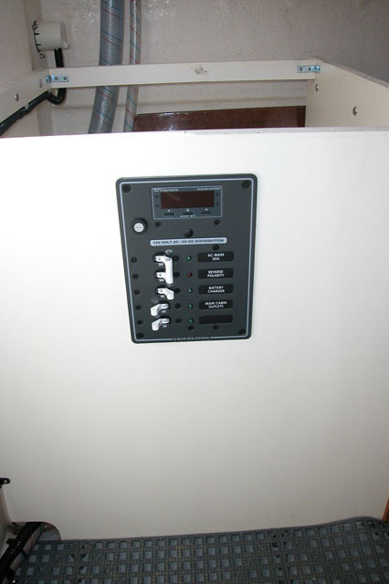 Blue Seas Systems AC panel mounted in port aft seat box.  It has a digital mulitmeter built in