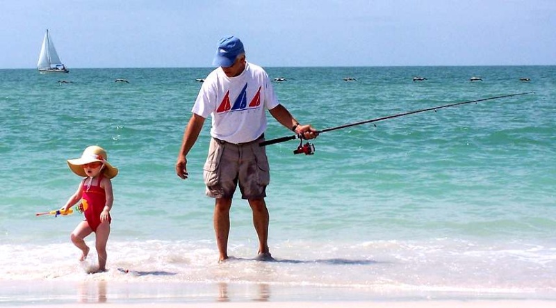 Boats,Pelicans, Fishing Pole and grandbaby Emma is enjoying sand and surf...Priceless!