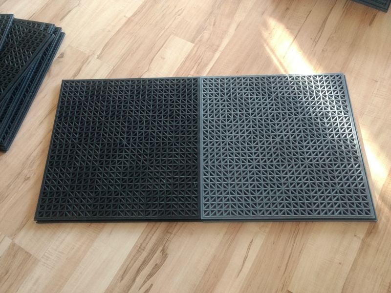 Bought some garage floor tiles from Costco. Choices were all black or gray/black.

I"m hoping this will help keep the feet clean and dry.