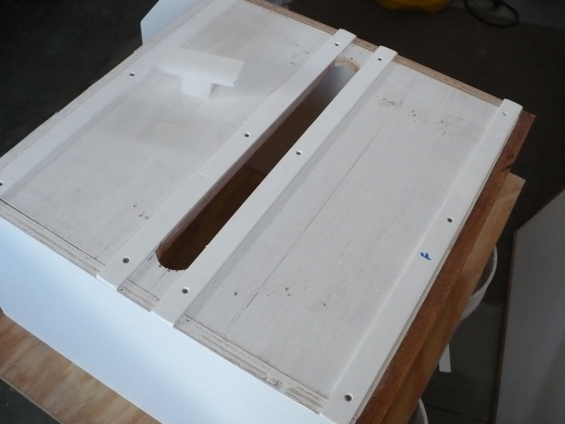 Box rides on PVC glides made from ripping down PVC lattice trim purchased at Home Depot. Its very slippery and does not leave any marks on the floor.