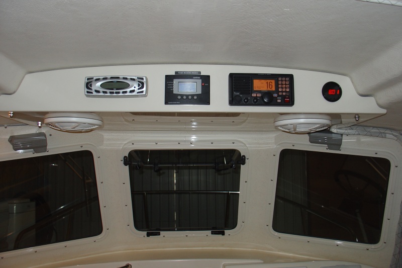 Built larger overhead console so that it is supportd by two bolts on each side and deep enough to handle 10" speakers.  Unit was gelcoated to look like factory finish.
